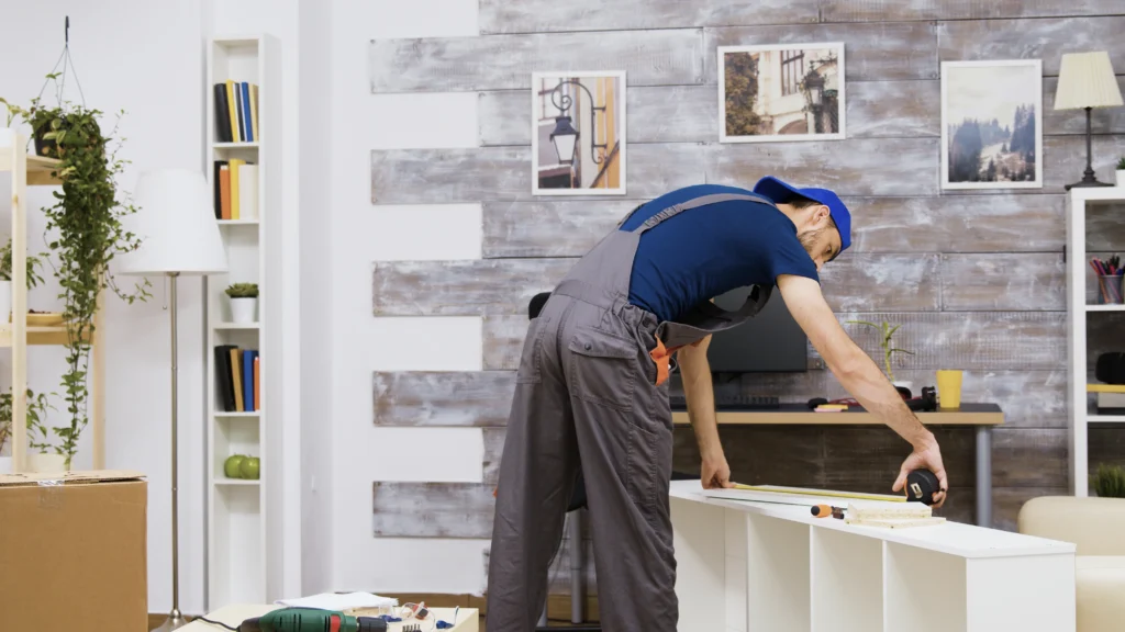 A man working on furniture in a room.