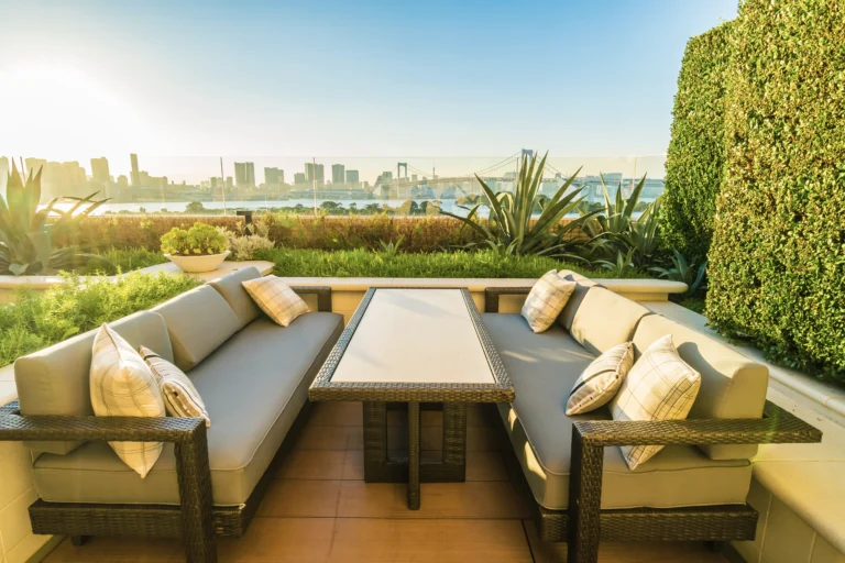 A patio with a table and chairs on the ground