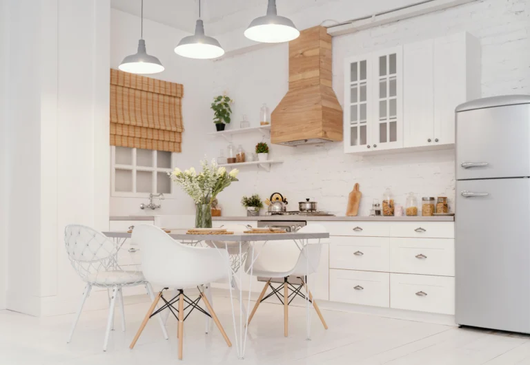 A kitchen with white cabinets and chairs in it